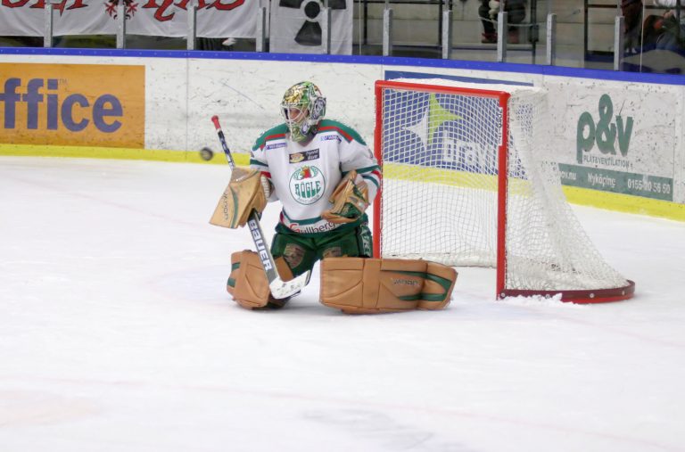 Goalie stopping a puck