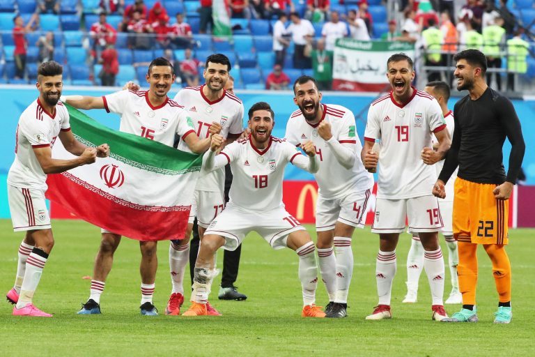St Petersburg, Russia. 15th June, 2018. ST PETERSBURG, RUSSIA - JUNE 15, 2018: Iran's Ramin Rezaeian, Reza Ghoochannejhad, Mehdi Taremi, Alireza Jahanbakhsh, Roozbeh Cheshmi, Majid Hosseini, and Amir Abedzadeh (L-R) pose with an Iranian national flag as t