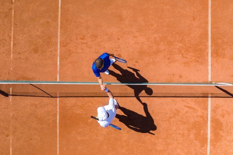 Tennis Players Greeting Each Other Over the Net Tennis Players Greeting Each Other Over the Net